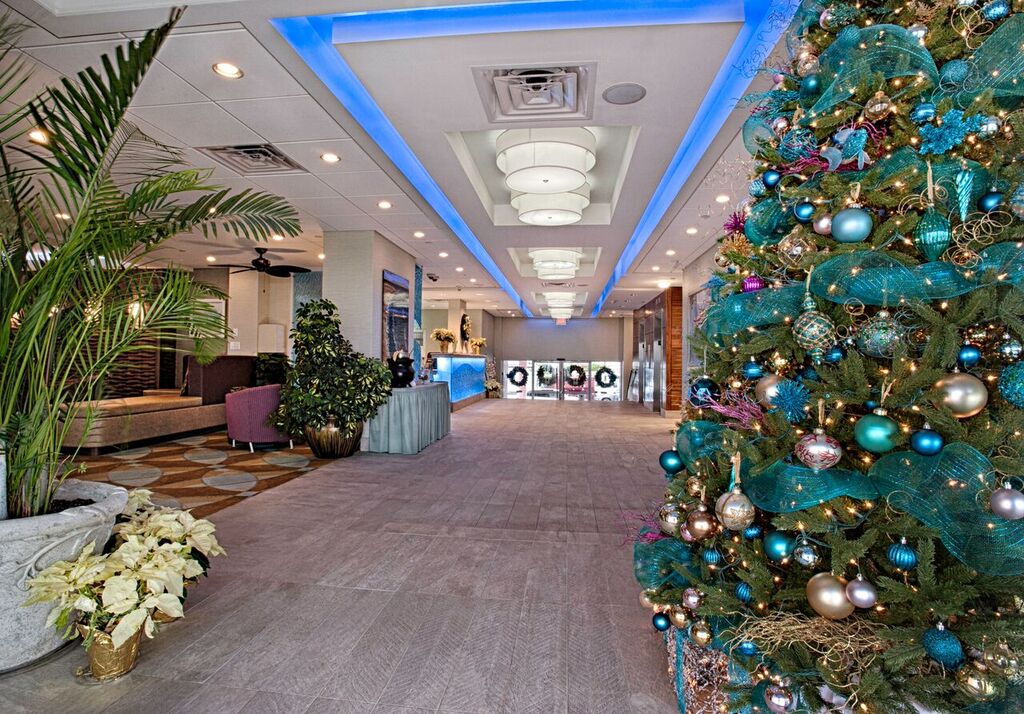 Port-O-Call lobby with Christmas tree, poinsettias, and wreaths